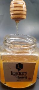 Lohee's natural honey dripping from honey dipper
